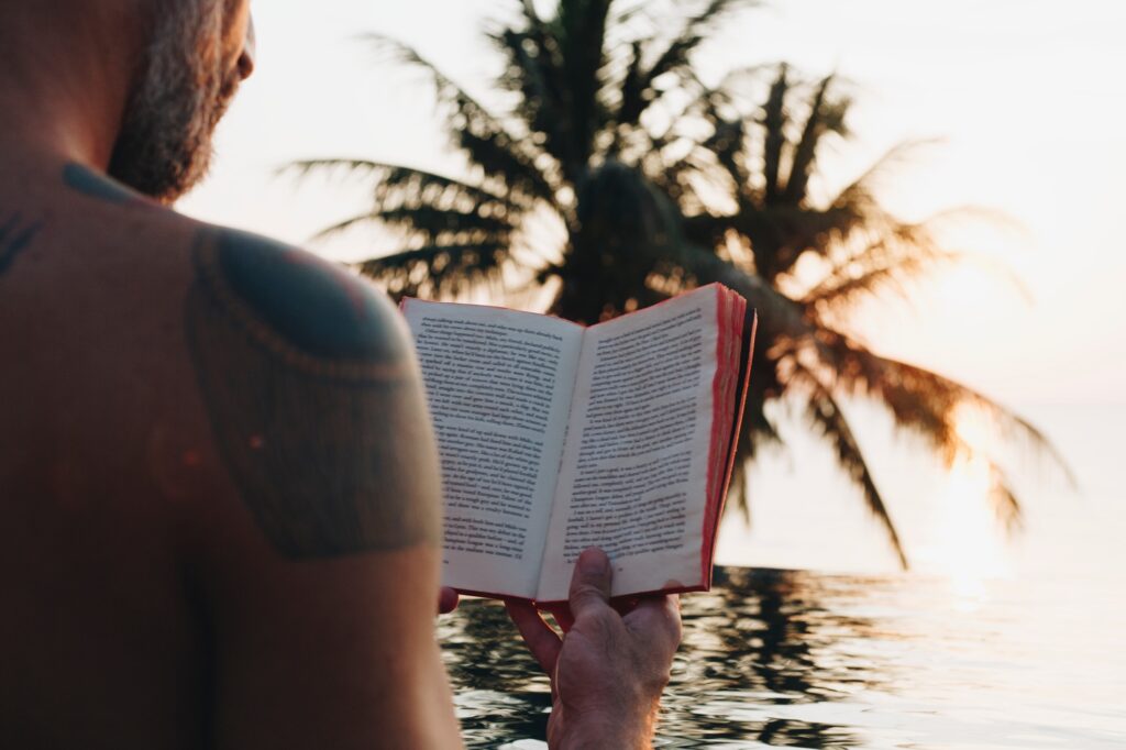 Man reading a book in the swimming pool