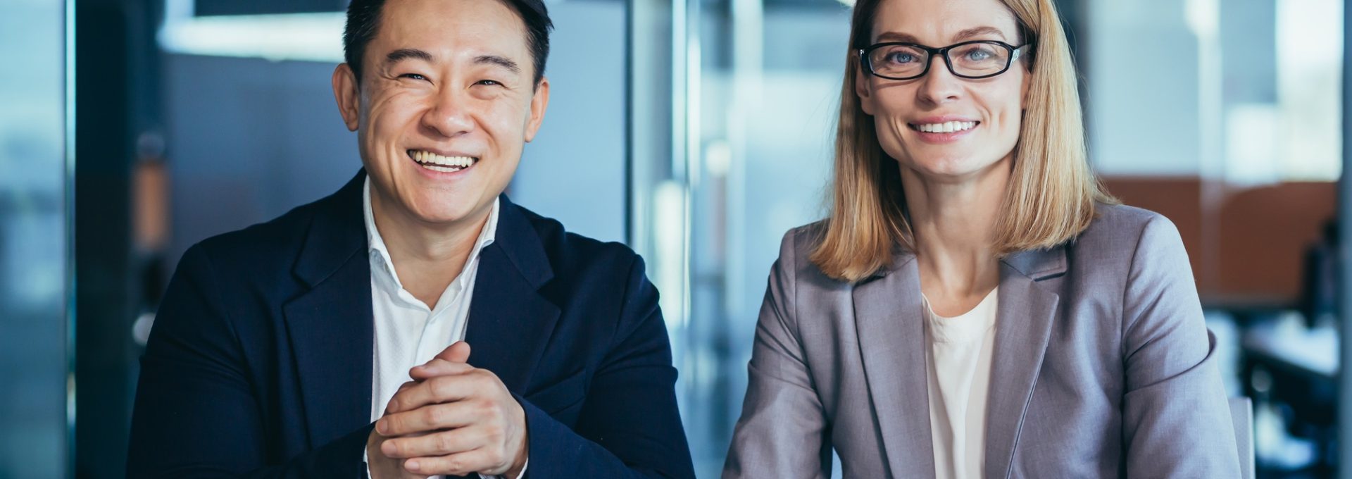 a team of business employees at an online meeting look at camera and communicate.
