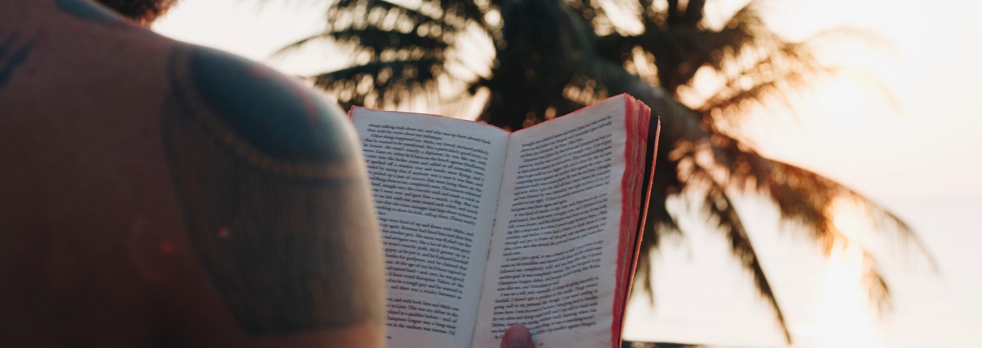 Man reading a book in the swimming pool