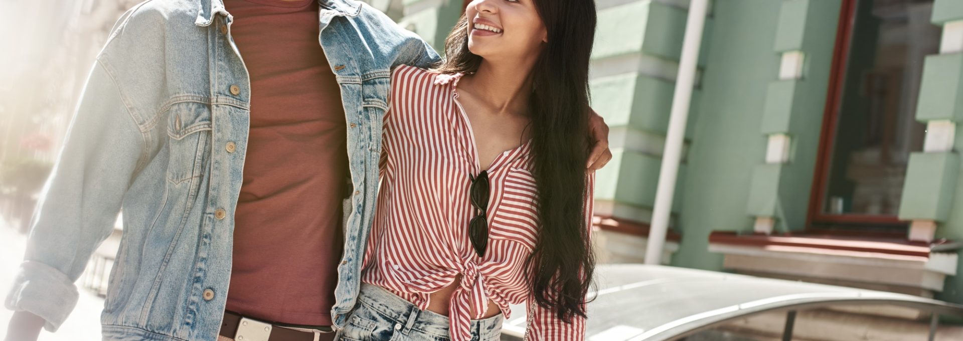 Romantic Relationship. Young diverse couple walking on the city street hugging looking at each other
